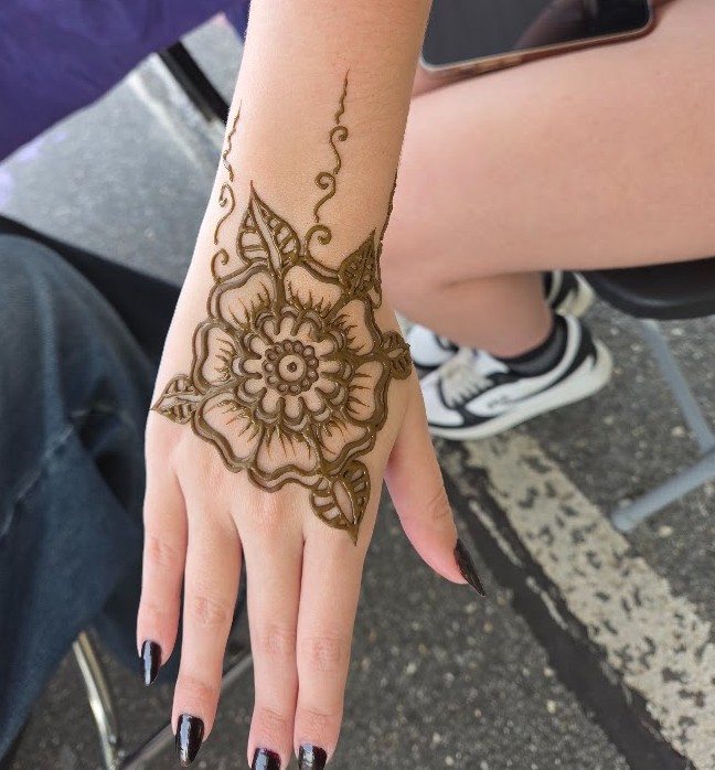 wet henna paste applied on a hand in a flower design at a new jersey festival